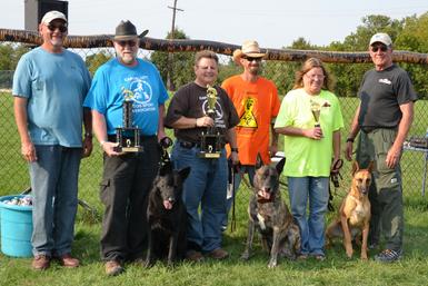 Cheryl Carlson & her Dutch Shepherd Becker winning the MI K-9 Challenge Protection Dog Tournament in 2012.  This picture is more amazing as all the dogs that placed in the Advanced Division (1st-Dutch Shepherd Becker, 2nd-German Shepherd Paladin & 3rd-Belgian Malinois Elphaba) were bred by Cher Car Kennels!