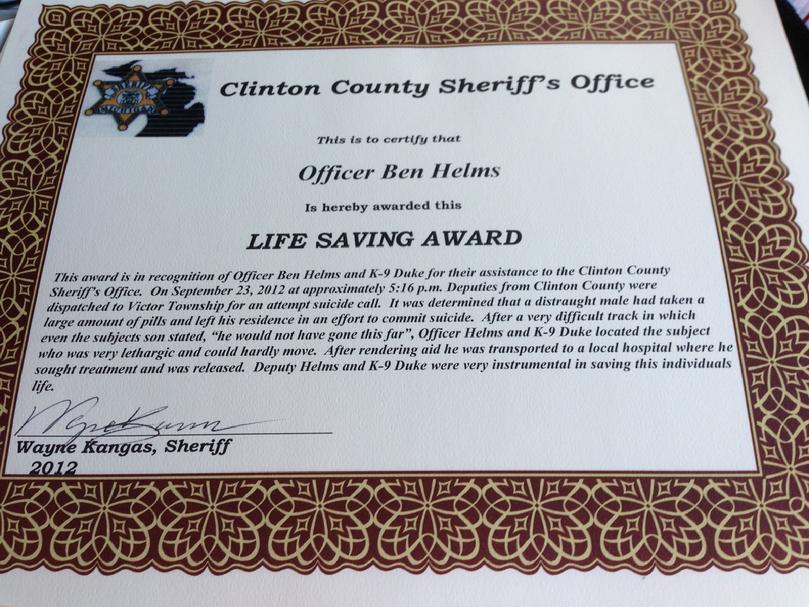 St. Johns Police Service Dog "Duke" and handler Ben Helms earn Life Saving Award from Clinton County Sheriff's Office 